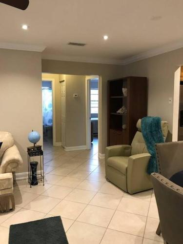 a living room with a couch and a chair at OCEAN VACATION BREEZE in Lantana