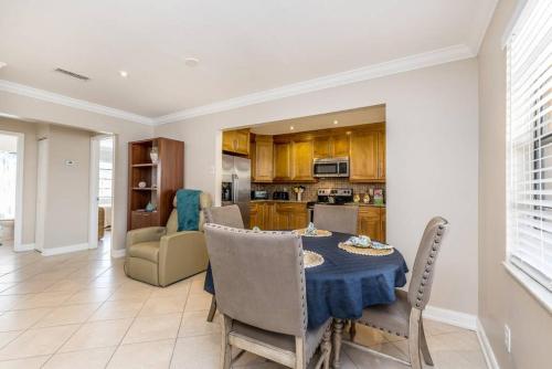 a kitchen and dining room with a table and chairs at OCEAN VACATION BREEZE in Lantana