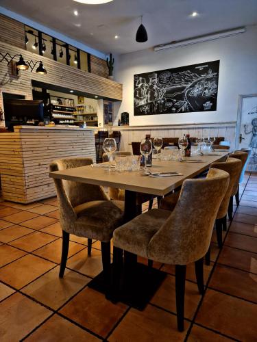 a dining room with a long table and chairs at Le Relais de la Calèche in Le Beausset