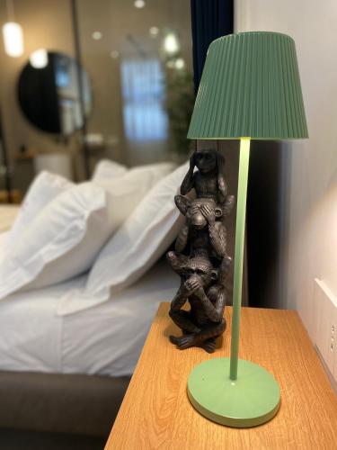 a statue of a bear sitting on a table next to a lamp at Nu House Rooms & Apartments in Cassano delle Murge