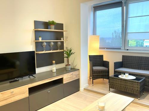a living room with a large flat screen tv at Modern Havanna Appartment in Graz