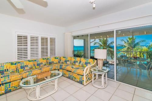 a living room with a couch and a table at Beach Living at Discovery Point Club in West Bay