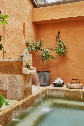 a swimming pool with a waterfall in a backyard at Hacienda el Potrero - Un lugar para siempre recordar in Suesca