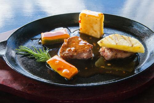 a black plate of food with meat and cheese at COCOS Hotel Antigua - All Inclusive - Adults Only in Bolans