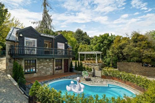 an exterior view of a house with a swimming pool at Alpine Cottage in Queenstown