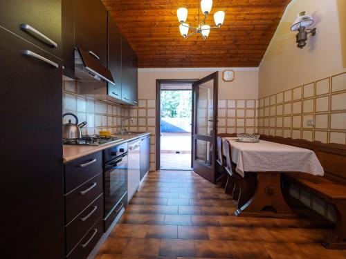 a kitchen with a table in the middle of it at Villa Cenerentola Malpensa in Turbigo