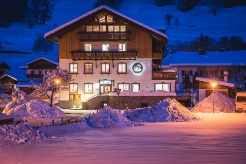 a large building in the snow at night at Haus am Rank in Oberstdorf