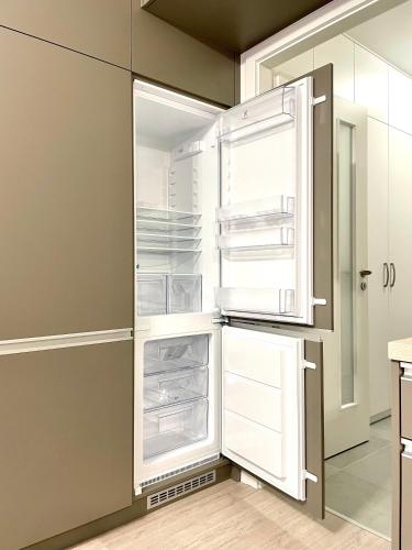 an empty refrigerator with its door open in a kitchen at Great in Nivy