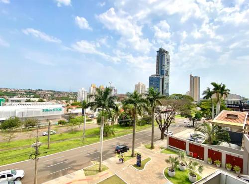 a city view of a street with palm trees and buildings at Loft Executivo-Afonso Pena in Campo Grande