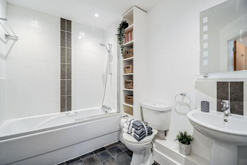 a white bathroom with a toilet and a sink at Entire Apartment Sleeps 4 Near The River Thames - #1515 in Maidenhead