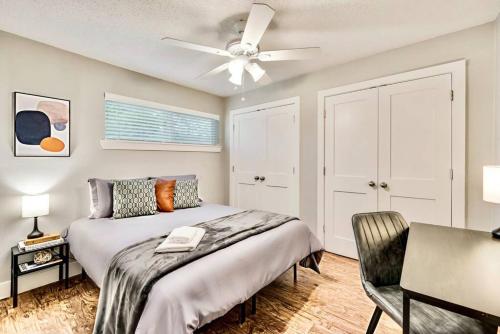 a bedroom with a bed and a ceiling fan at Love for Dallas: Close to Deep Ellum & AAC! in Dallas