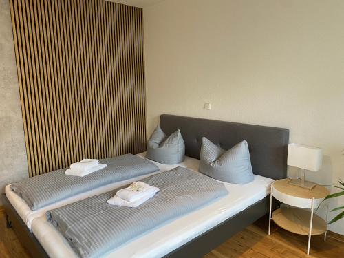 a bed with two pillows on it in a room at RR - Tiny Apartment - Parking - Kitchen - Netflix in Magdeburg