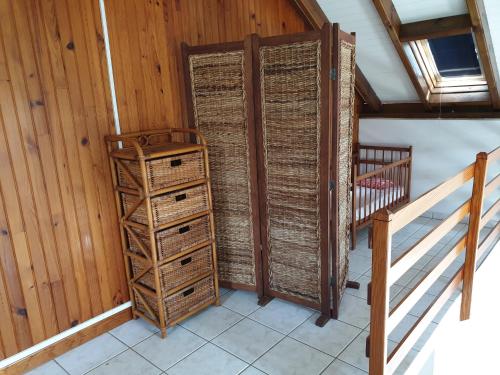 a room with a wooden door and a dresser at Chez Gisèle et Philippe in Terre-de-Haut