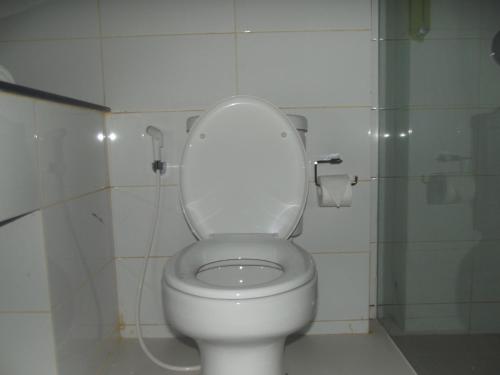 a bathroom with a toilet with the lid up at L Bajo Hotel in Labuan Bajo