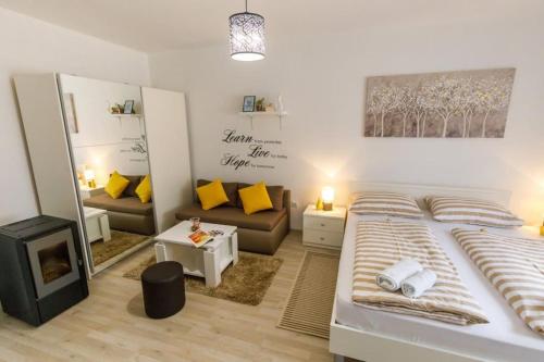 a bedroom with a large bed and a living room at Kuća za odmor ARIJA sa velikim vanjskim bazenom in Knin