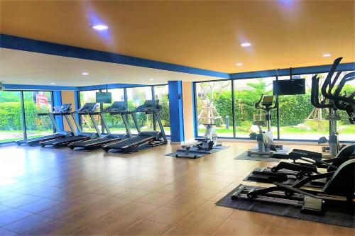 a gym with rows of treadmills and elliptical machines at Hua Hin First-Hin Nam in Hua Hin