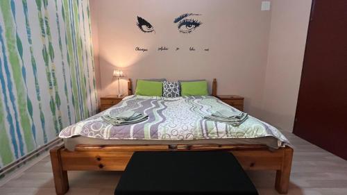 a bedroom with a bed with eyes on the wall at Apartman-Suite "Marinero" in Vršac