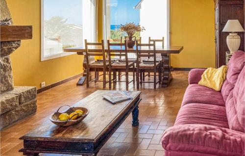 a living room with a couch and a table at Awesome Home In Trévou Treguignec in Trélévern