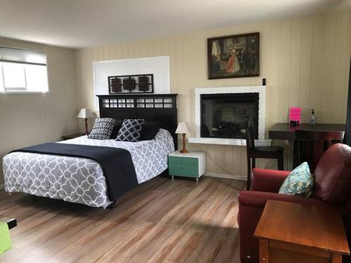 a bedroom with a bed and a fireplace and a couch at 2 bedroom house or Private Studio in quiet neighborhood near SF, SFSU and SFO in Daly City