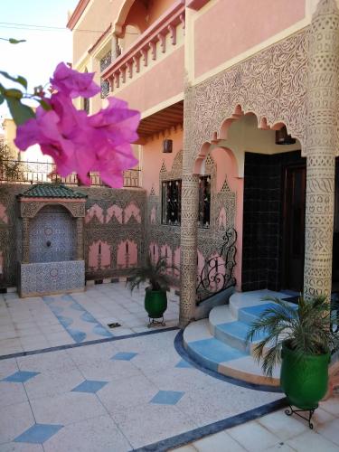a building with a pink flower on the side of it at Villa Eden in Ouarzazate