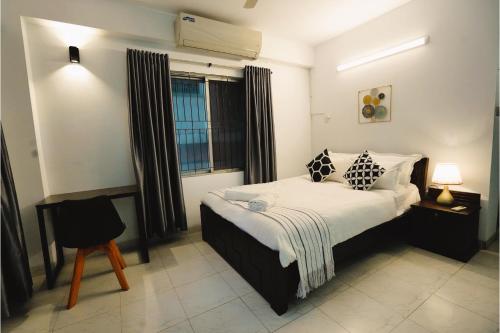 a bedroom with a large bed and a window at Gulshan Lovely 3-Bedroom Luxury Apartment in Dhaka