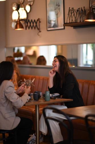 two women sitting at a table in a restaurant at Best Western Hotel Hebron in Copenhagen