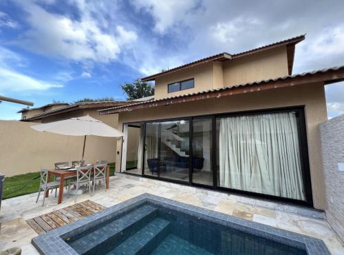 a villa with a swimming pool and a house at Fontes da Pipa by Liiv in Pipa