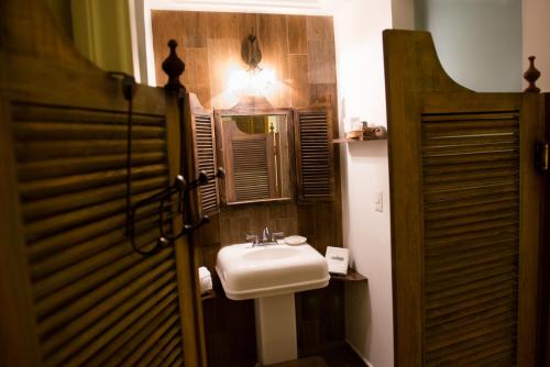 a bathroom with a white sink and a mirror at Grand Hotel Tepatitlán in Tepatitlán de Morelos
