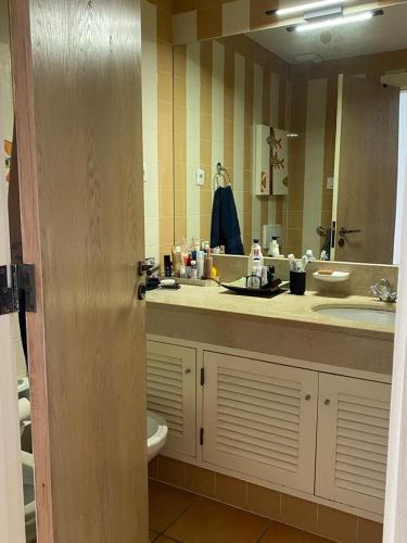 a bathroom with a sink and a mirror at House of Rising Sun in Quarteira