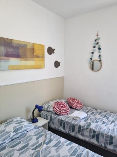 a bedroom with two beds and a picture on the wall at Riverside imbassai bloco B003 in Mata de Sao Joao