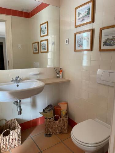 a bathroom with a sink and a toilet at House of Rising Sun in Quarteira