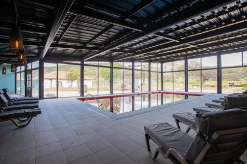 a large room with lounge chairs and windows at Hotel Boutique BC Wine Casablanca in Casablanca