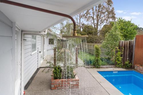 a house with a swimming pool and a fountain at Southern Comfort in Balnarring
