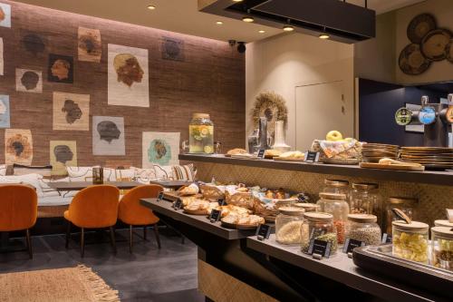 a buffet line with food on display in a restaurant at Boa Hotel - BW Signature Collection - Lille Centre Gares in Lille