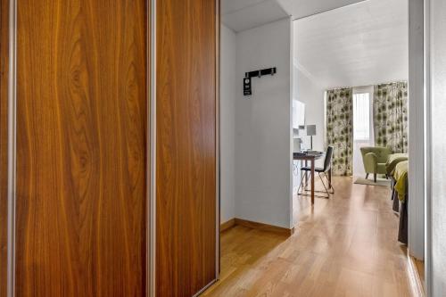 a room with a wooden door and a dining room at Best Western Royal Star in Stockholm