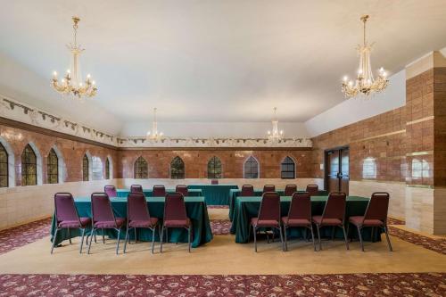 a large room with a table and chairs and chandeliers at Chateau Big Bear Boutique Hotel, BW Signature Collection in Big Bear Lake