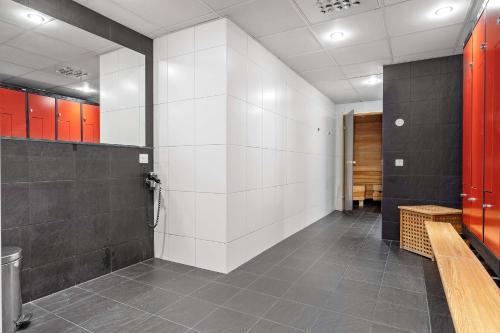 a bathroom with white walls and red cabinets at Best Western Royal Star in Stockholm