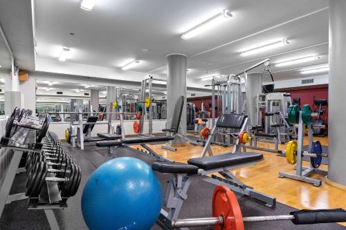 a gym with a lot of machines and a blue ball at Best Western Royal Star in Stockholm