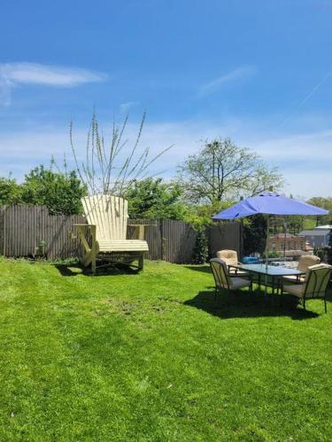 a yard with a table and chairs and an umbrella at 3 BR - Off Street Parking - Amazing View Nearby in Pittsburgh