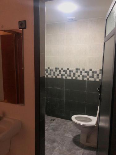 a bathroom with a toilet and a sink at Ayour Beach House 5 in Imsouane