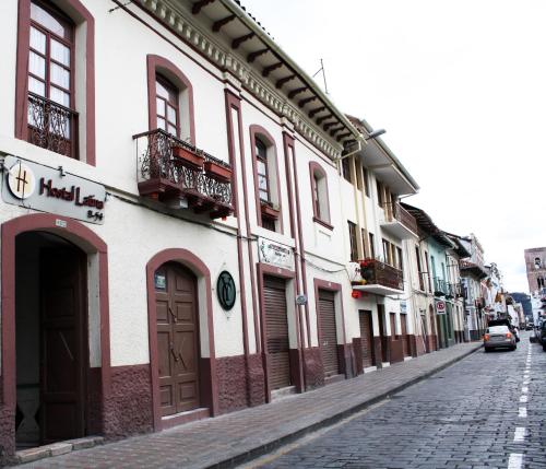 a cobblestone street next to a building at Hostal Latina in Cuenca