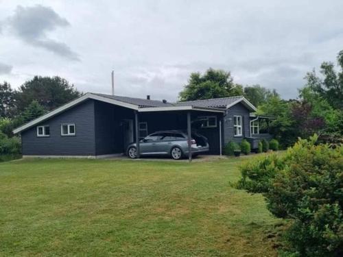 a house with a car parked in front of it at 7 person holiday home in Højslev-By Traum in Højslev