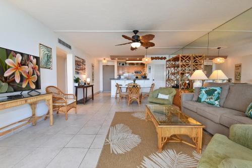 a living room with a couch and a table at May on Sale! Book Now for May and SAVE BIG! in Kahana