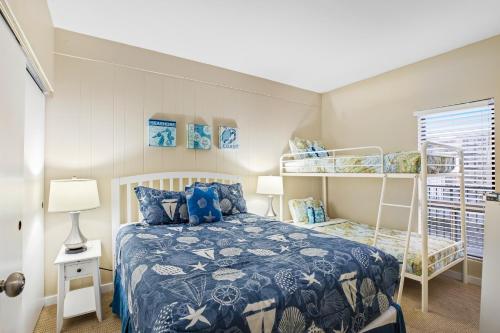 a bedroom with a bed and a bunk bed at Sand & Sea: The Holladay (418) in Seaside