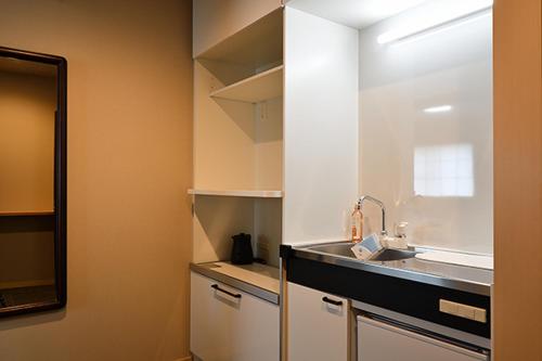 a kitchen with a sink and a counter top at Hotel Takimoto in Yamanouchi
