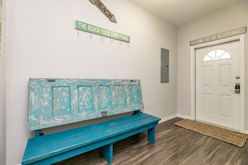 a blue bench in a room with a door at Port A Good Time in Port Aransas