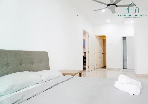 a white bedroom with a large bed and a ceiling fan at Gurney Drive Mansion One Serviced Apartment in George Town