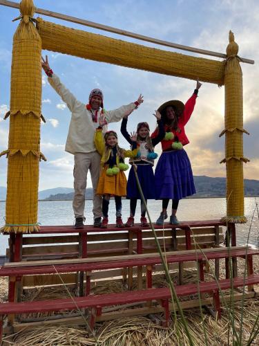 a group of people standing on a pier at TITICACA JALTAWI LODGE in Puno