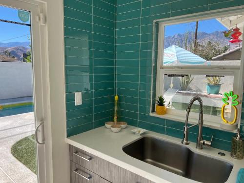 a kitchen with a sink and a window at Amarillo House - Luxury Home with Pool & Spa in Palm Springs