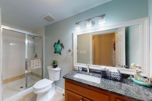 a bathroom with a toilet and a sink and a shower at Paradise Shores 107 A Slice of Paradise in Mexico Beach
